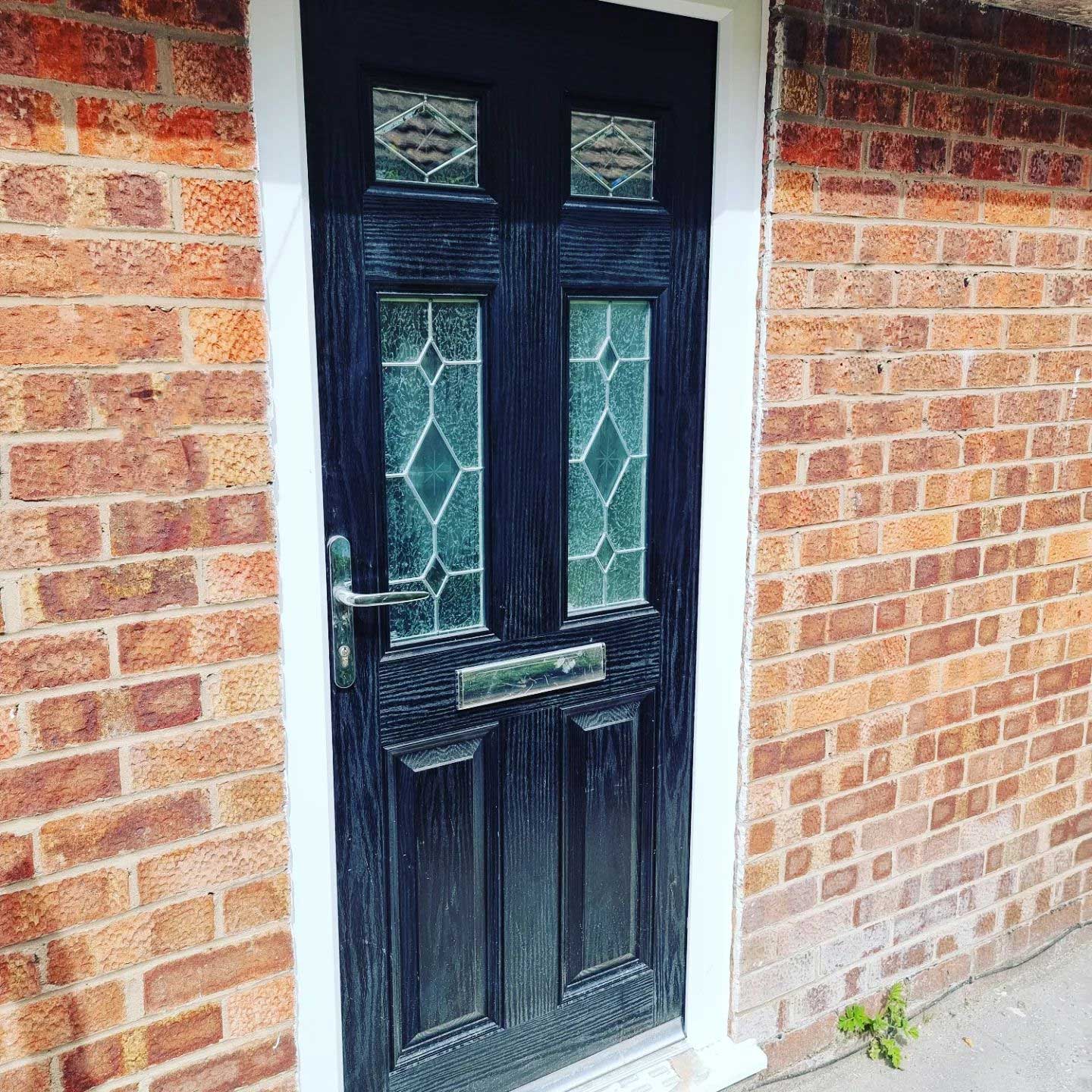 MAD Windows and Doors black composite door with frosted glass panels